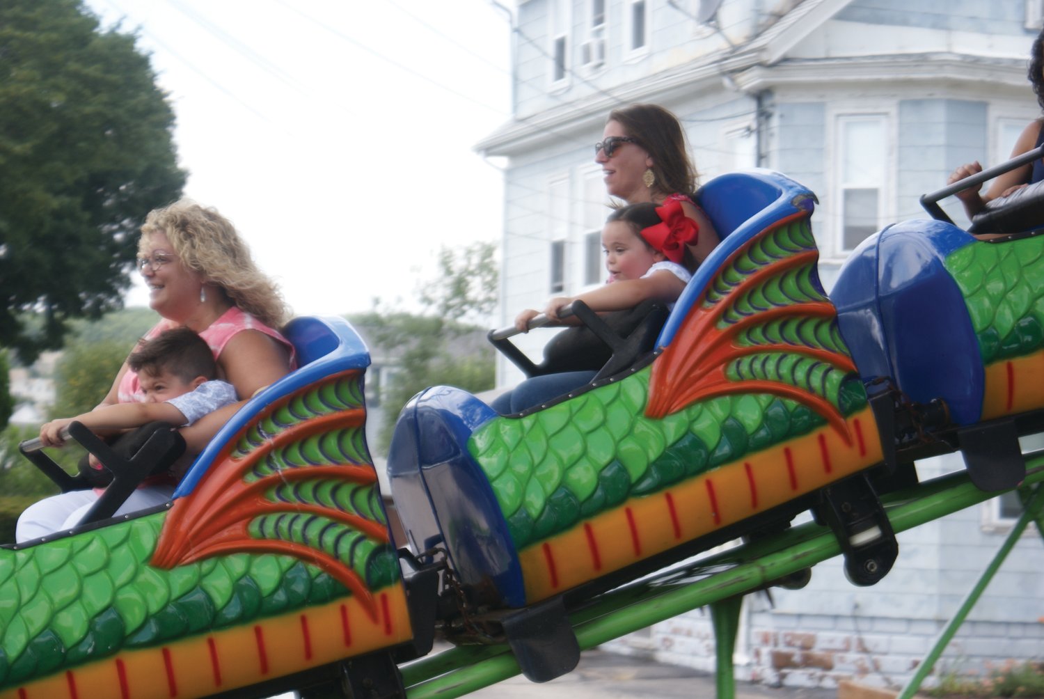 OUT FOR A RIDE: Families enjoy one of the carnival rides at this
year’s feast.